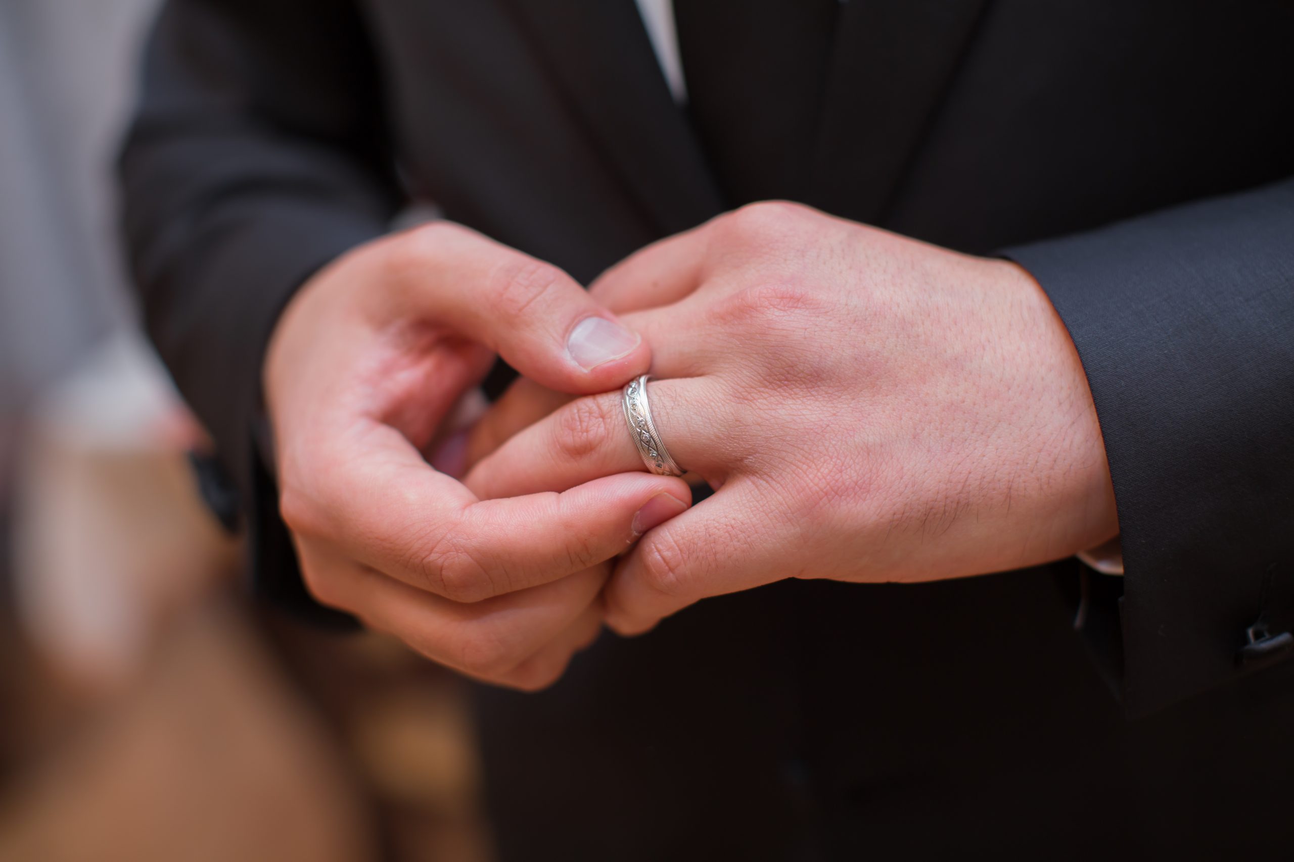 A man wearing a wedding ring