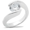 A silver ring features an oval diamond set in a unique curved design.