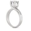 A silver engagement ring features a prominent round diamond held securely by four prongs.
