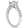 A diamond engagement ring with a large center stone and smaller accent stones set in a white gold band.