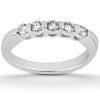 A silver ring with five clear gemstones set in a curved arrangement.