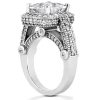 A silver ring features a large central clear gemstone surrounded by smaller clear stones and intricate detailing.
