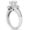 A diamond engagement ring with a prominent central stone and additional smaller stones on the band is displayed against a white background.