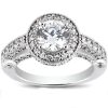 A silver ring with a large round diamond surrounded by smaller diamonds on a decorative band.