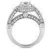 A silver ring with a large central clear gemstone is surrounded by smaller clear stones, featuring an intricate design with geometric shapes.