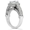 A silver engagement ring with a central gemstone, surrounded by intricate diamond detailing and smaller stones along the band.