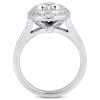 A silver engagement ring features a large central diamond surrounded by smaller stones and intricate band design.