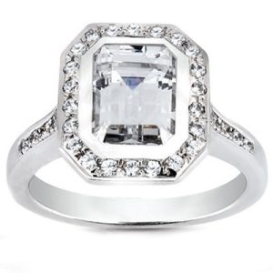 An elegant silver ring features a large, rectangular clear gemstone surrounded by smaller diamonds.