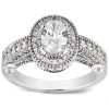 A silver ring featuring an oval-shaped, clear gemstone surrounded by small decorative stones.