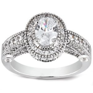 A silver ring featuring an oval-shaped, clear gemstone surrounded by small decorative stones.