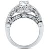 A silver ring with a large central clear gemstone and multiple smaller diamonds embedded in the band.
