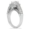 A silver engagement ring features a large central diamond surrounded by smaller gemstones and a decorative band.