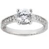 A silver engagement ring with a large round diamond centerpiece and smaller accent diamonds along the band.