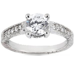 A silver engagement ring with a large round diamond centerpiece and smaller accent diamonds along the band.