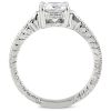 A silver ring with a large, rectangular gemstone is displayed prominently against a white background.