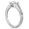 A silver engagement ring with a large central diamond and intricate detailing on the band.