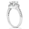 A silver ring features a large central diamond and smaller stones along the band.