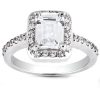 A silver ring features a prominent rectangular diamond surrounded by smaller stones on its band.