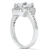 A silver engagement ring features a large rectangular clear stone set at the top with smaller stones along the band.