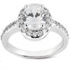 A silver ring with a large oval clear gemstone surrounded by smaller sparkling stones.