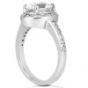 A silver ring features a large central gemstone with smaller stones accenting the band.