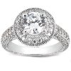 A silver ring with a large round diamond centerpiece surrounded by smaller diamonds on the band.