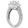 A detailed silver engagement ring features a large central diamond surrounded by smaller stones on the band.