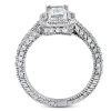 A silver ring with a large rectangular center stone and multiple smaller stones along the band is displayed.