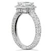 A silver engagement ring with a prominent clear gemstone is displayed at an angle, highlighting its intricate band design.