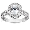 A diamond ring with a central oval gemstone surrounded by smaller diamonds on a polished silver band.