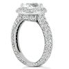A diamond engagement ring with a round center stone and intricate pave detailing on the band.