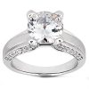 A silver engagement ring featuring a large round diamond center stone and smaller diamonds set in the band.
