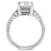 A silver ring featuring an elongated, faceted clear stone set prominently at the top.