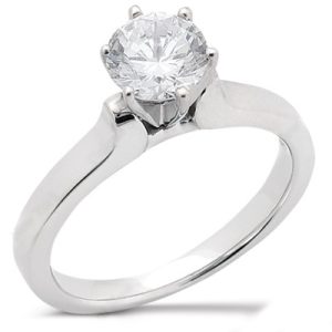 A silver engagement ring featuring a large round diamond at the center.