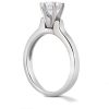 A silver engagement ring with a clear diamond prominently positioned at the top.