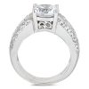 A silver ring with a large clear gemstone and smaller decorative stones on the band.