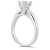 A silver engagement ring with a round diamond prominently displayed on the setting.