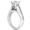 A silver engagement ring features a prominent round diamond at the top and small accent diamonds along the band.