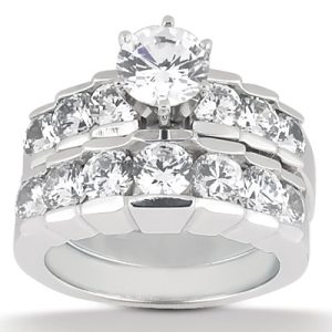A silver jewelry ring featuring a large central diamond surrounded by smaller diamonds in a stacked design.