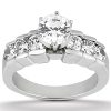 A silver engagement ring features a large central diamond surrounded by smaller diamonds.