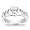 A silver engagement ring with a large round center diamond and smaller diamonds set along the band.