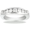A silver band ring features a row of alternating large and small diamonds embedded along the top.