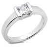 A silver engagement ring with a square-cut clear gemstone is displayed.