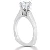 A silver engagement ring with a diamond setting is displayed at an angle.