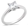 A silver engagement ring features a clear princess-cut diamond at the center.
