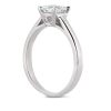 A silver engagement ring with a large central diamond is displayed from the side.