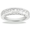 A silver ring features a row of square-cut diamonds set in a prong-style setting.