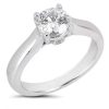 A silver ring with a large, round, brilliant-cut diamond is displayed prominently.