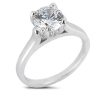 A silver engagement ring with a large round diamond prominently displayed on a simple band.