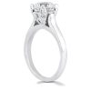 A silver engagement ring features a prominently set clear diamond surrounded by smaller diamonds.